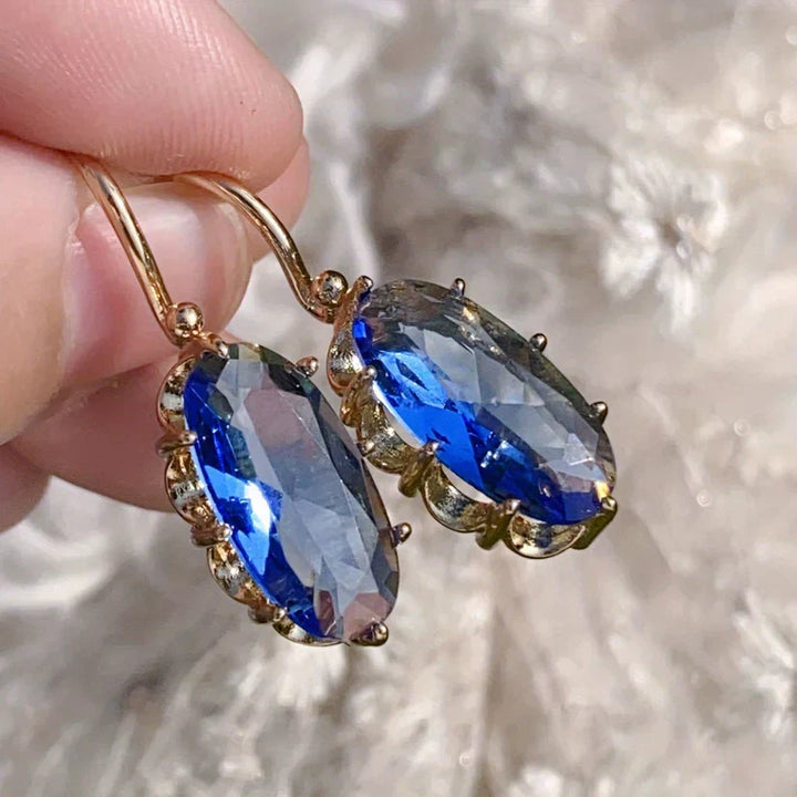 Brincos Dourados com Flor Azul